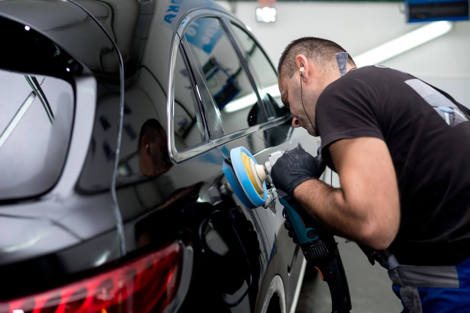Car detailing expert from Yorkville waxing a car.